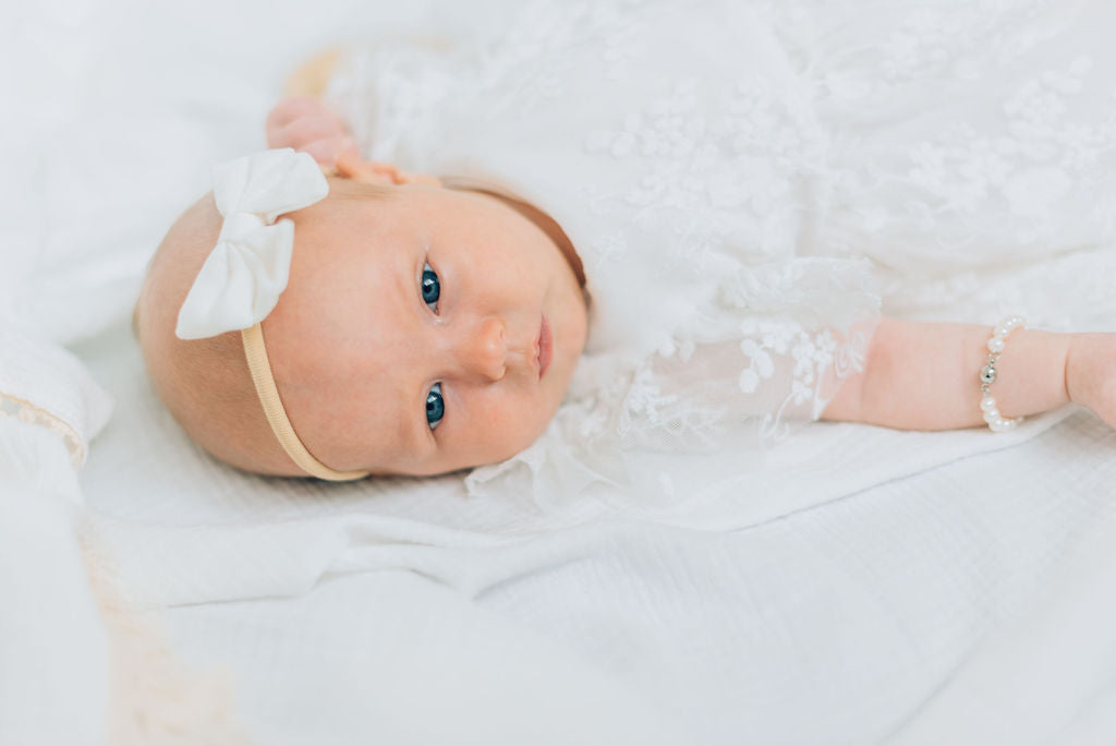 Detail shot of white baby bow.