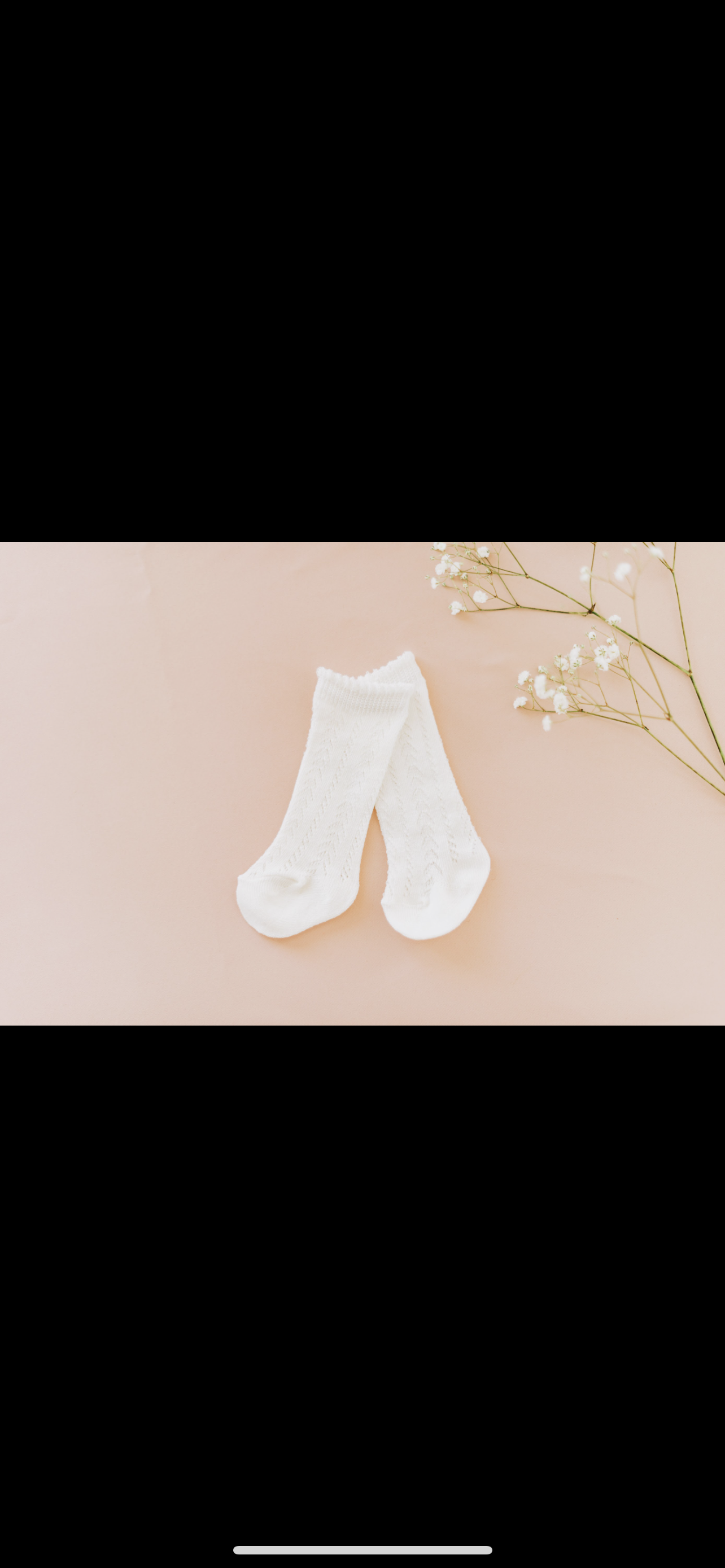 White socks on flat lay with white flowers