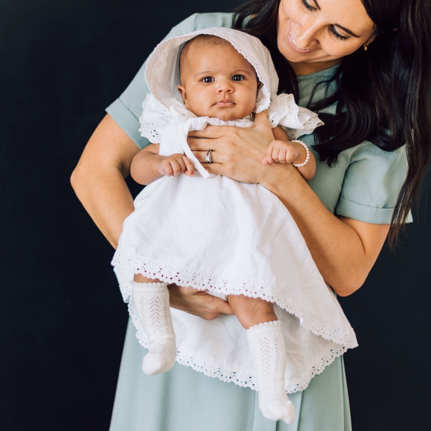 Mom looking at baby in baby blessing attire